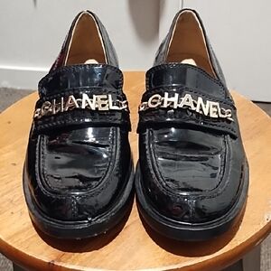 Authentic CHANEL Black Patent Leather Loafers with Gold Accents